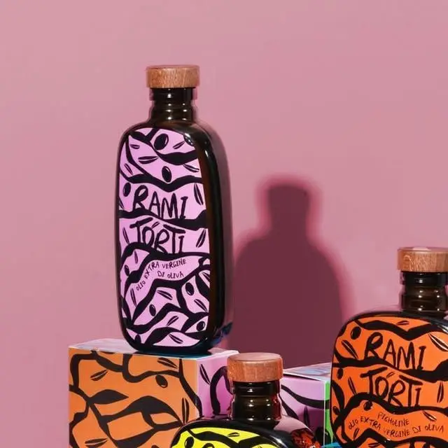 Rami Torti olive oil bottles with illustrated labels on pink backdrop