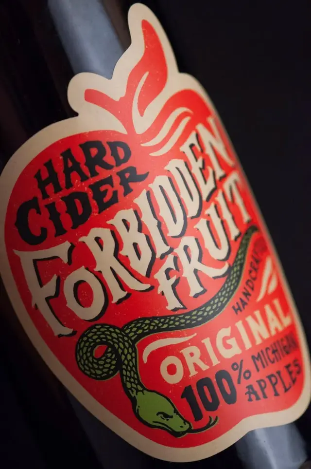 Forbidden Fruit Hard Cider — red apple-shaped label with coiled snake