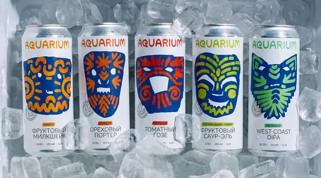 AQUARIUM beer cans with colorful tribal-mask labels chilled on ice