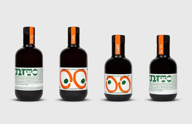 Minimal amber glass bottles with graphic orange-and-green label (product shot)