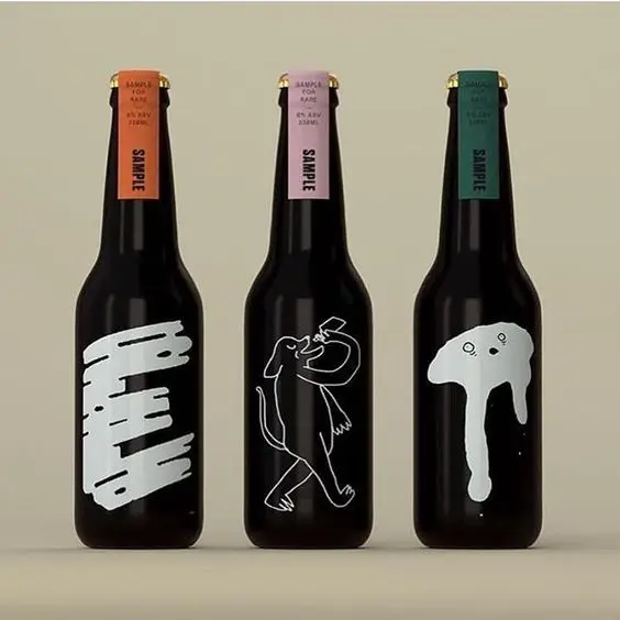 Three black beer bottles with white graphic labels and colored 'SAMPLE' neck tags