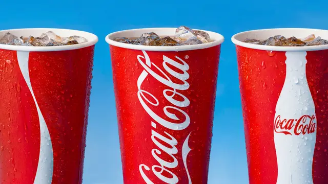 Close-up of three red Coca-Cola fountain cups with ice and condensation