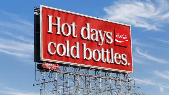 Coca‑Cola billboard — "Hot days cold bottles." (outdoor ad, Atlanta)