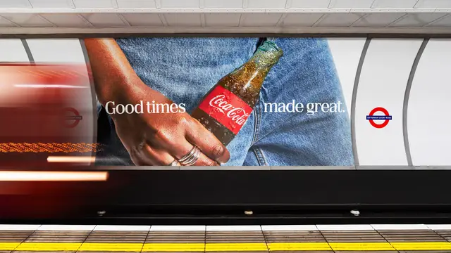 Coca‑Cola 'Good times made great.' billboard on London Underground platform