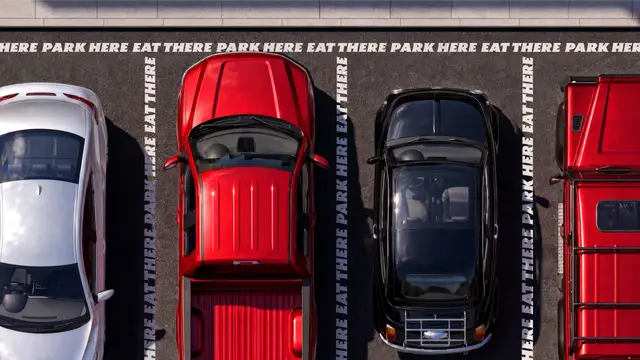 Top-down parking lot with stenciled 'EAT THERE PARK HERE' pavement copy