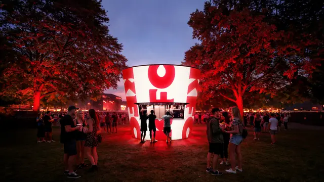 KFC illuminated circular pop‑up kiosk at outdoor festival