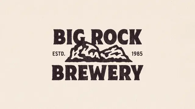 Big Rock Brewery logo — vintage stamped wordmark with rock illustration (ESTD. 1985)