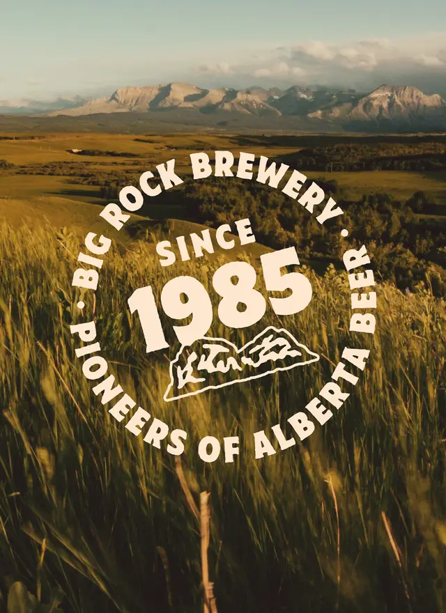 Big Rock Brewery 'Since 1985' circular badge over Alberta wheatfield