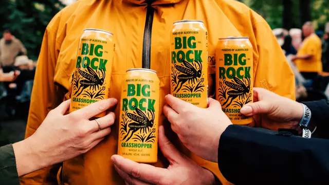 Big Rock Grasshopper beer cans — group toast, yellow jackets
