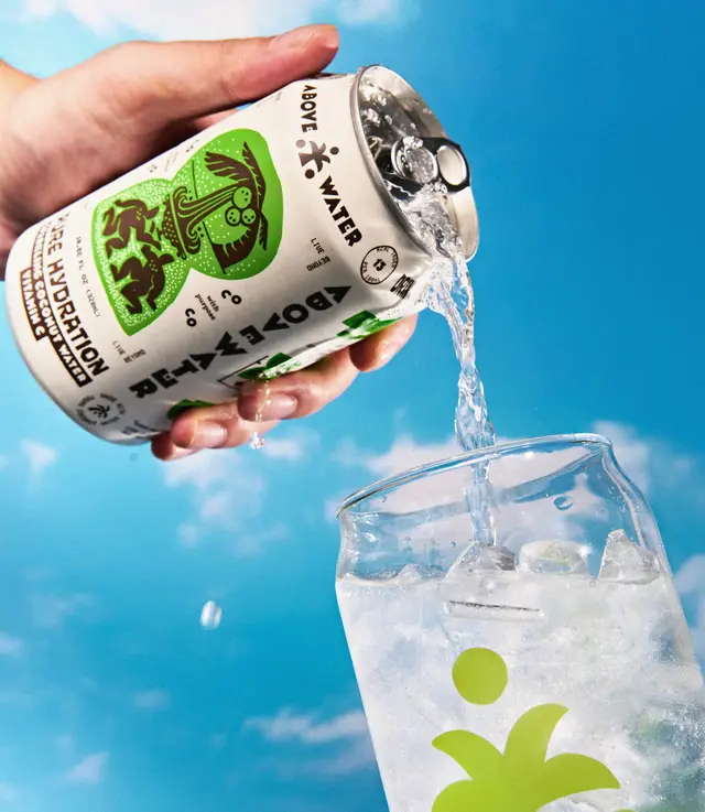 Above Water canned beverage being poured into ice-filled glass