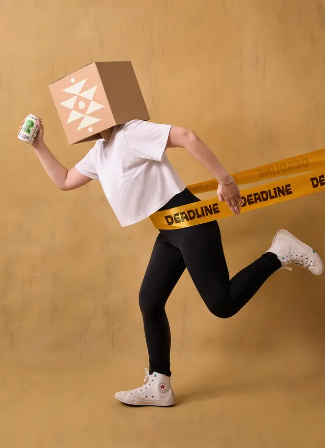Above Water packaging photo — figure with cardboard-box head wrapped in 'DEADLINE' tape