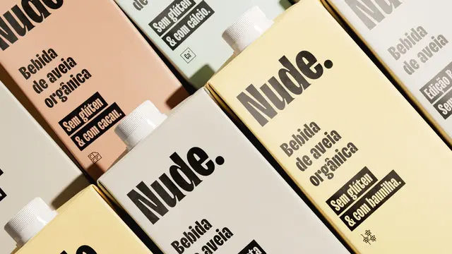 Nude oat milk packaging — pale pastel cartons with bold typographic logo