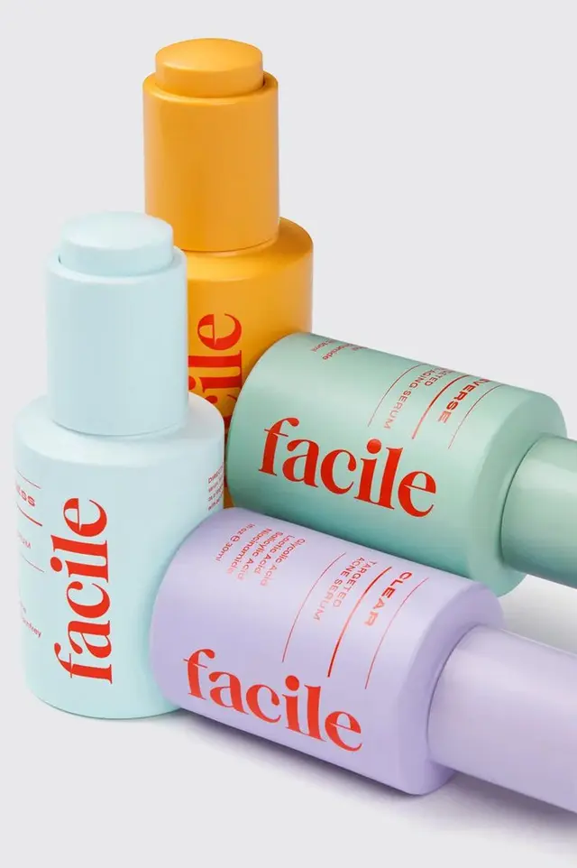 Facile skincare product lineup held by diverse hands