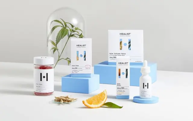 Healist CBD packaging — clean studio still life with botanical cloche