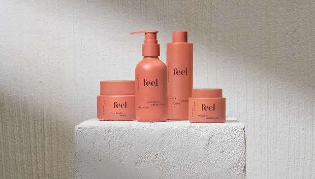 Feel skincare — matte terracotta packaging set on plaster pedestal