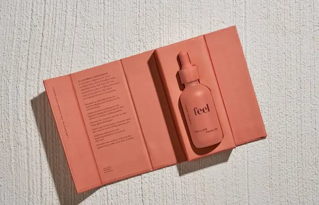 Feel skincare — terracotta matte packaging on textured pedestal