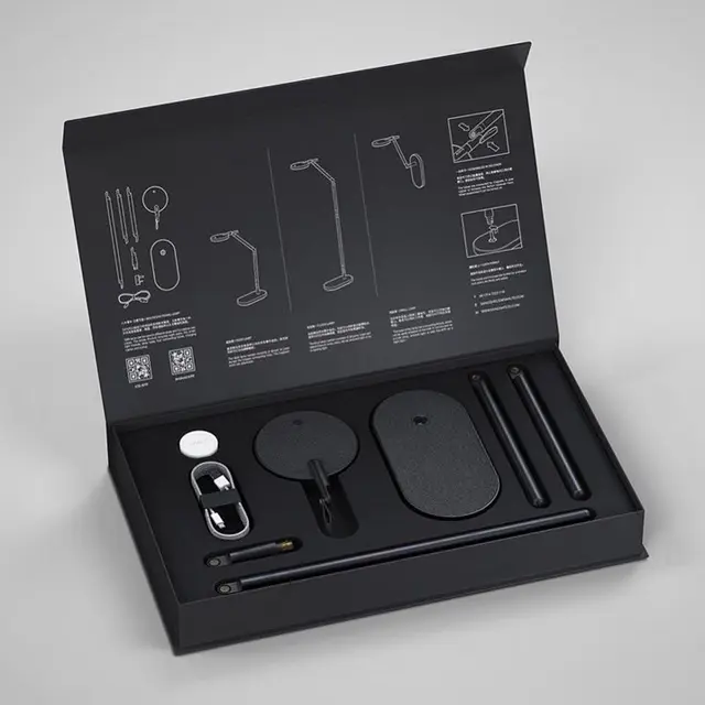 Minimalist black desk-lamp kit in hinged box — flat‑lay product shot
