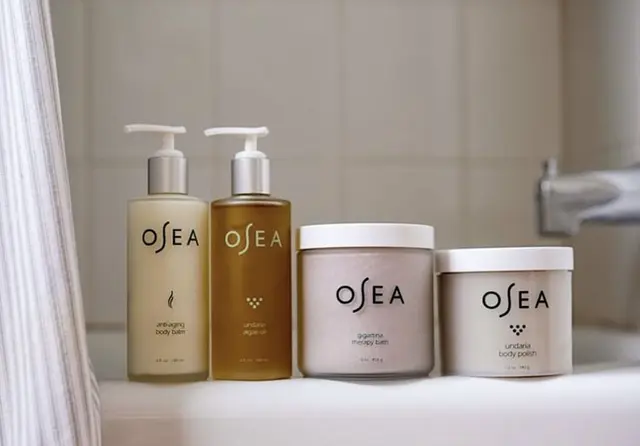 OSEA Body Care Products — Pump Bottles and Jars on Bathtub Ledge