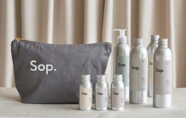 Sop. minimal aluminum body-care bottles on ceramic tray — sustainable packaging by The - D