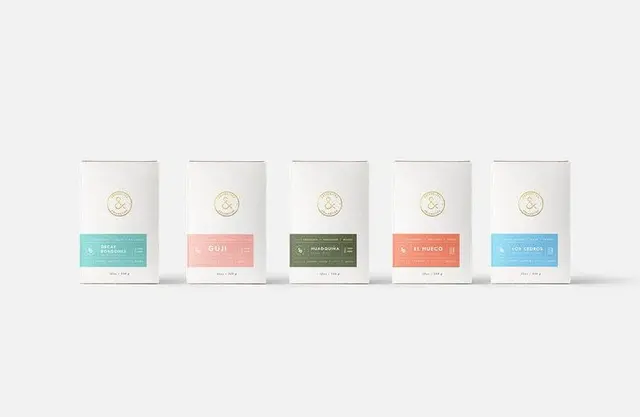 Coffee & Tea Collective clean white packaging with color-blocked labels