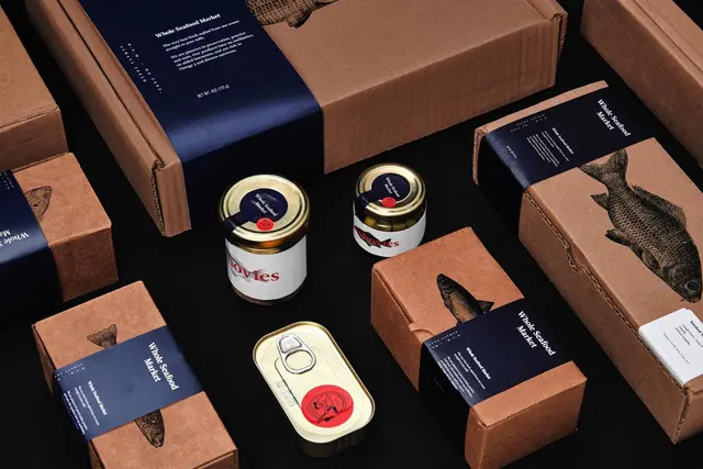 Whole Seafood Market — kraft boxes with navy belly bands and ink fish illustrations