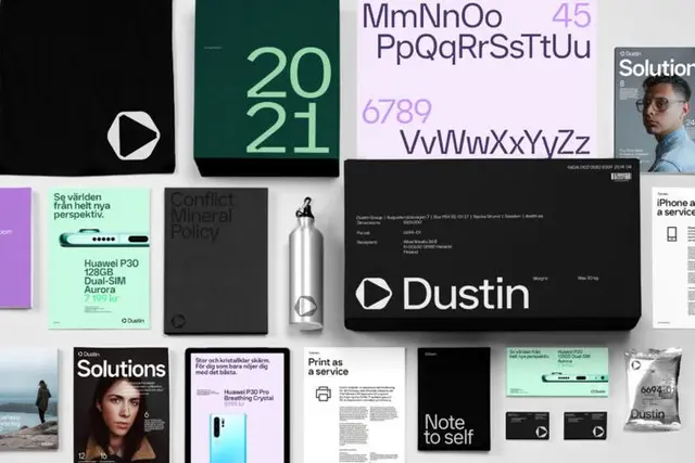 Dustin exterior signage — black wordmark and play icon on white facade