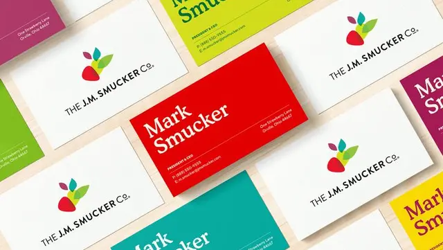 The J. M. Smucker Co. — old illustrative strawberry mark vs new abstract fruit/leaf logo (