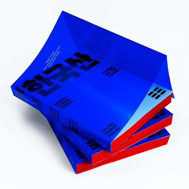 Stack of cobalt-blue paperbacks with red fore-edges and bold Korean typography