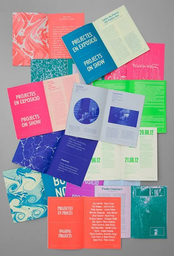 Projectes en Exposició — colorful exhibition brochures (flat lay)