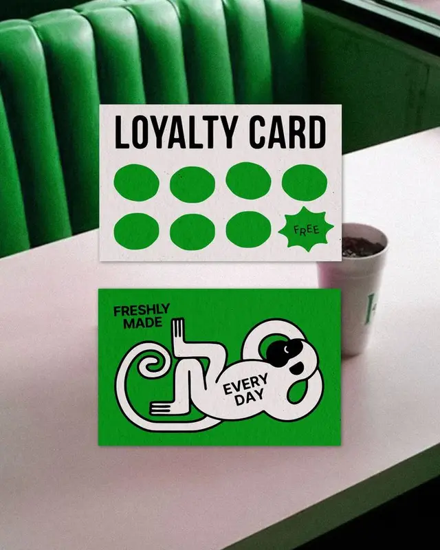 Green diner scene with loyalty punch card and promotional card
