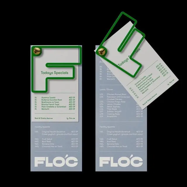 Minimal restaurant menu cards with green tubular clip and brass fastener
