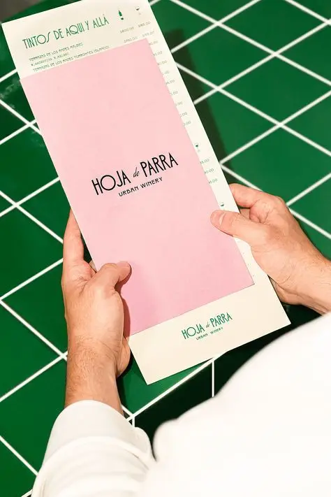 Hoja de Parra — Pink wine menu on green tiled table