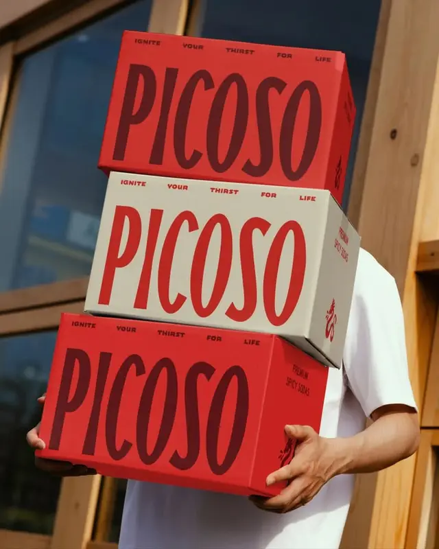 PICOSO stacked beverage packaging — bold red typographic boxes
