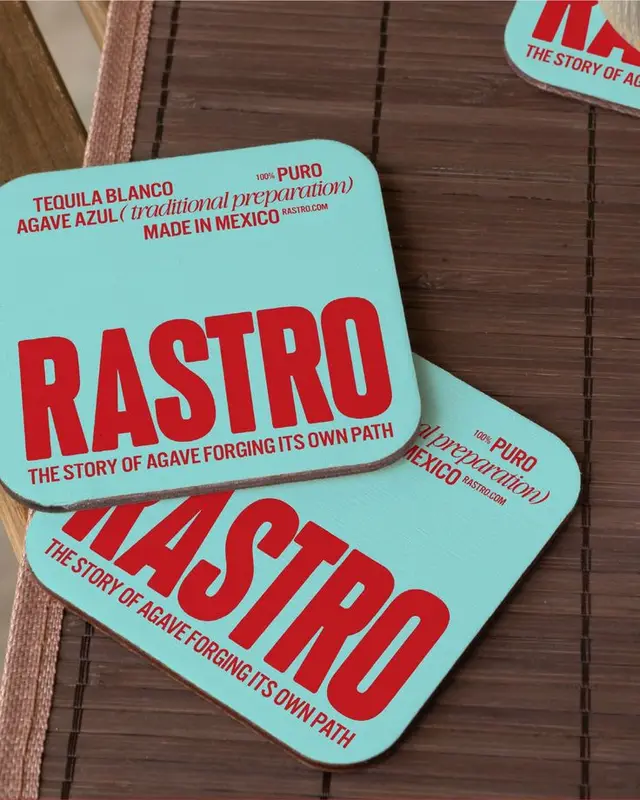 RASTRO turquoise promotional coasters — bold red typography