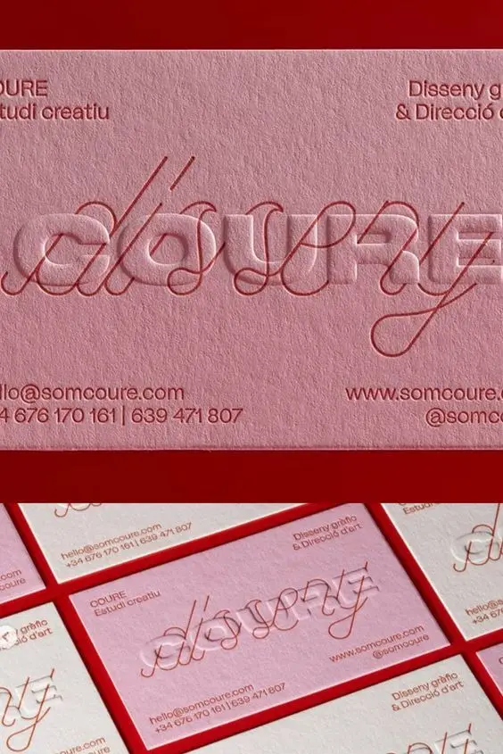 Embossed pink business cards with cursive 'somcoure' logo