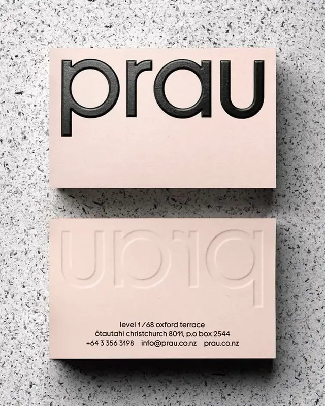 Prau blush-pink business cards — black debossed logotype and blind embossed reverse