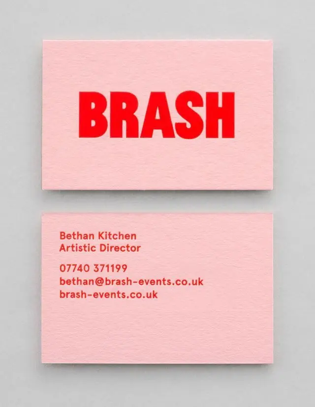 Pink BRASH business cards with bold red logo and contact details