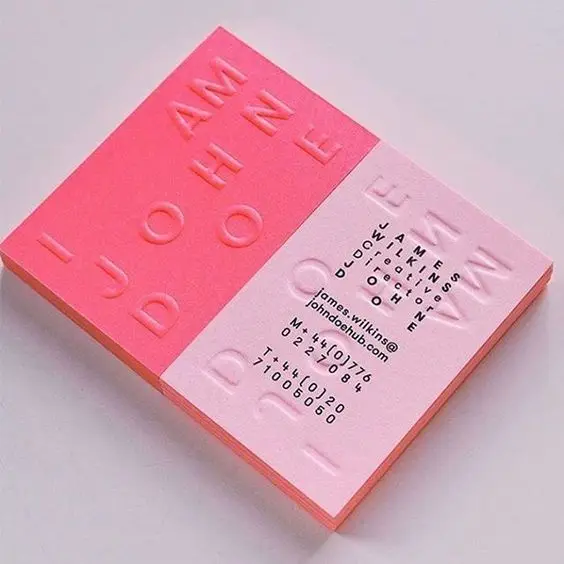 Two-tone pink embossed business card with bold typographic split