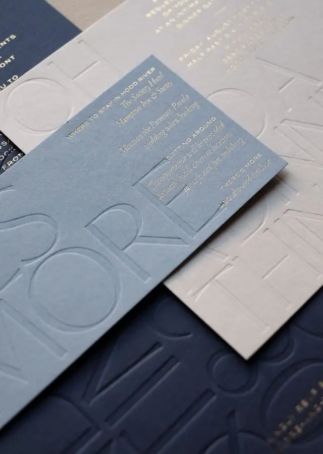 Blind‑embossed wedding stationery with gold‑foil accommodation card