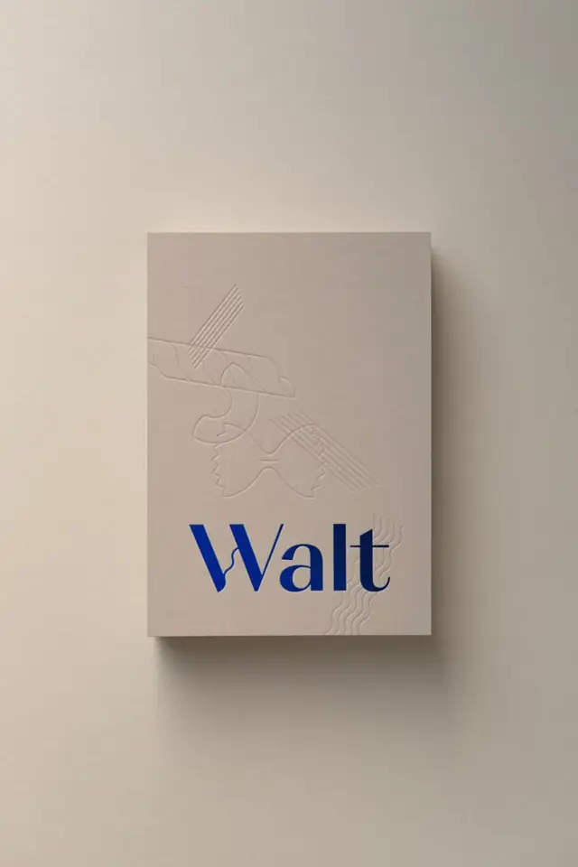 Cream embossed hardcover with cobalt blue 'Walt' wordmark