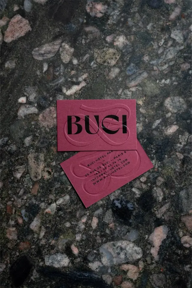 BUCI embossed business cards on dark terrazzo slab