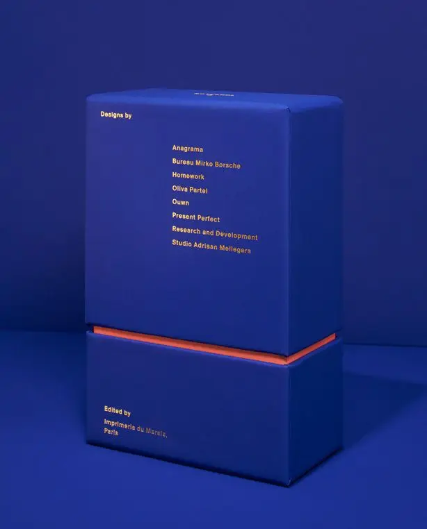 Cobalt blue two-piece box with orange interior and gold foil credits