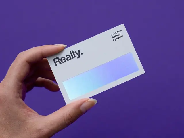 Minimal business card with holographic foil on purple background