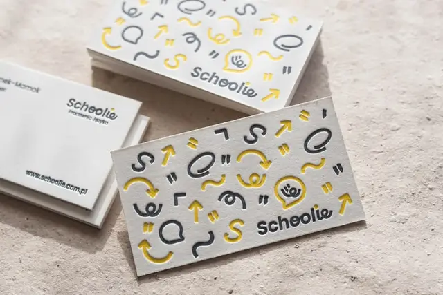 Schoolie embossed business cards with yellow & gray icon pattern