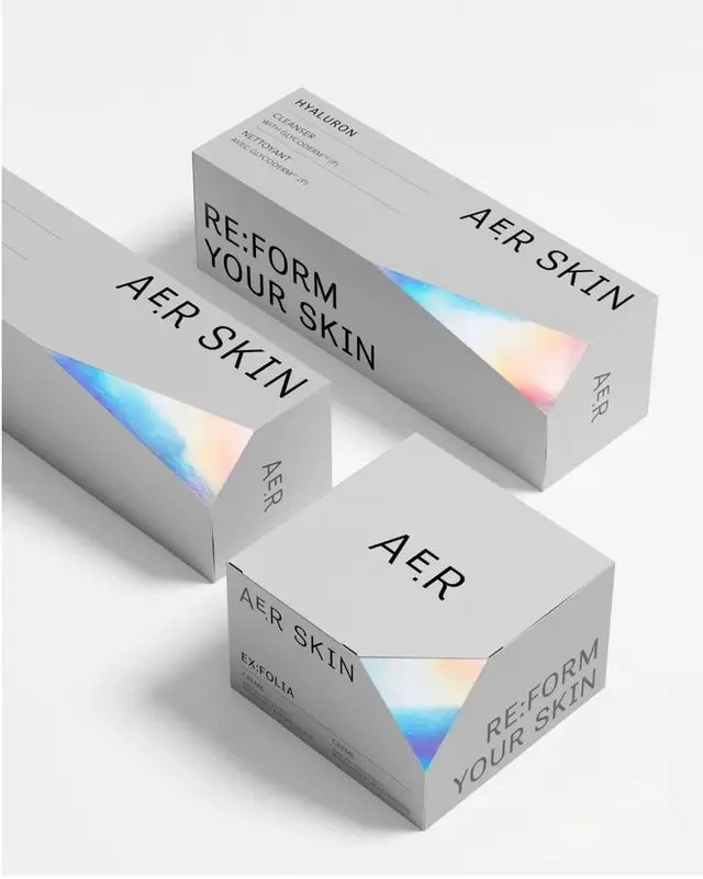 AER Skin minimalist packaging with iridescent triangular insets