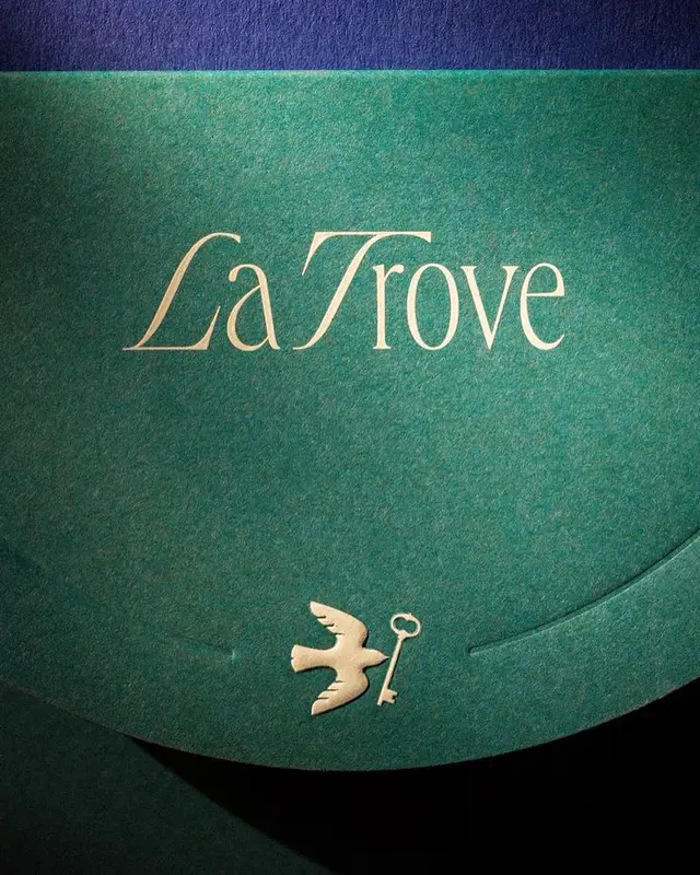 La Trove gold-foil logotype on emerald textured stationery