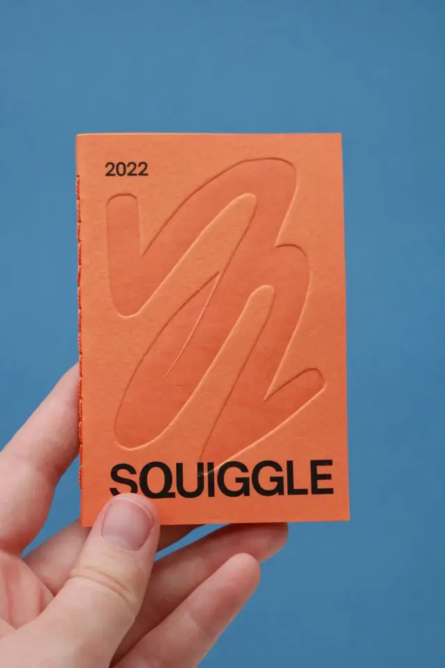 Orange 'SQUIGGLE' 2022 pocket notebook with embossed cover