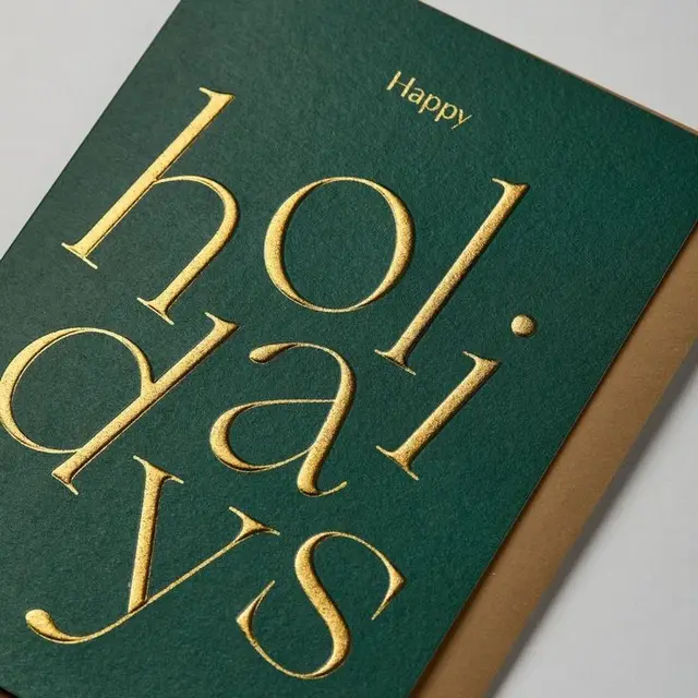 Forest green holiday card with gold foil typography
