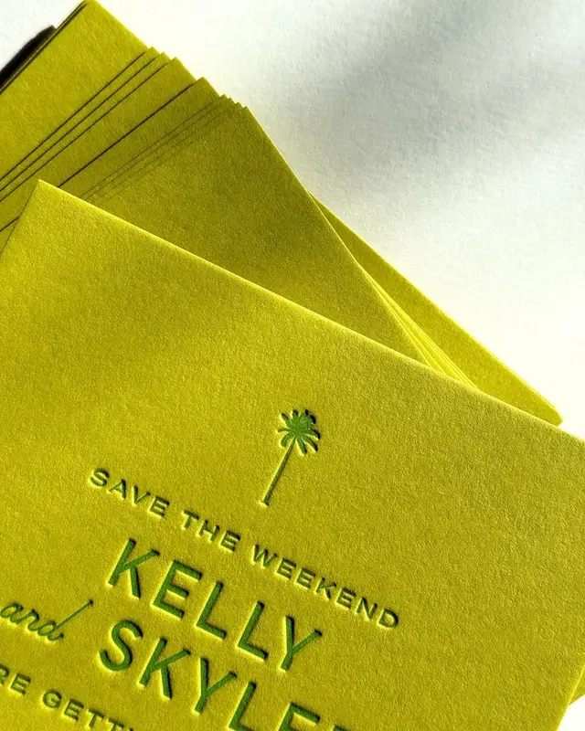 Neon chartreuse letterpress save-the-date cards with palm tree motif