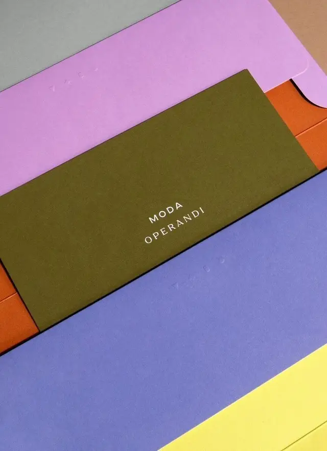 Moda Operandi — layered color‑blocked stationery flat lay